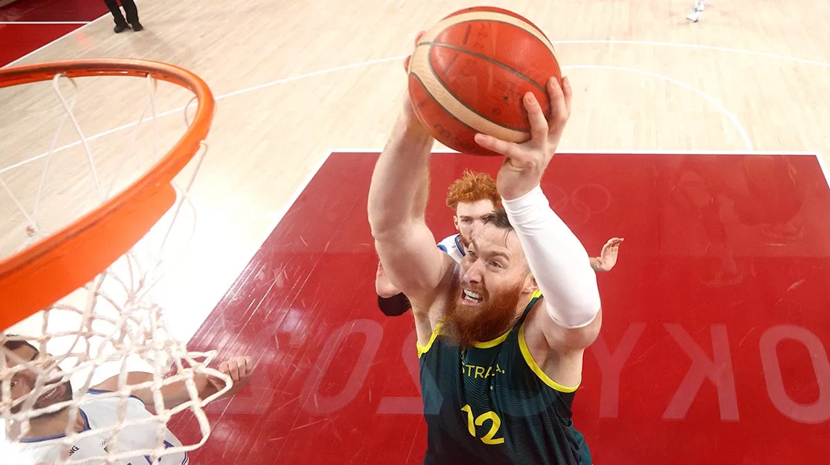 Aron Baynes #12 of Team Australia goes up for a dunk against Italy during the second half of a Men's Preliminary Round Group B game on day five of the Tokyo 2020 Olympic Games at Saitama
