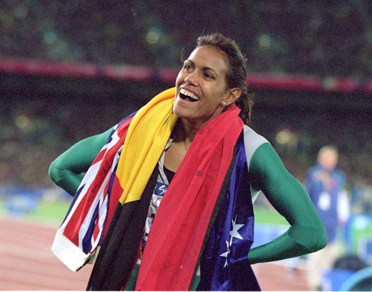 Catherine Freeman with the Australia and Aboriginal flags