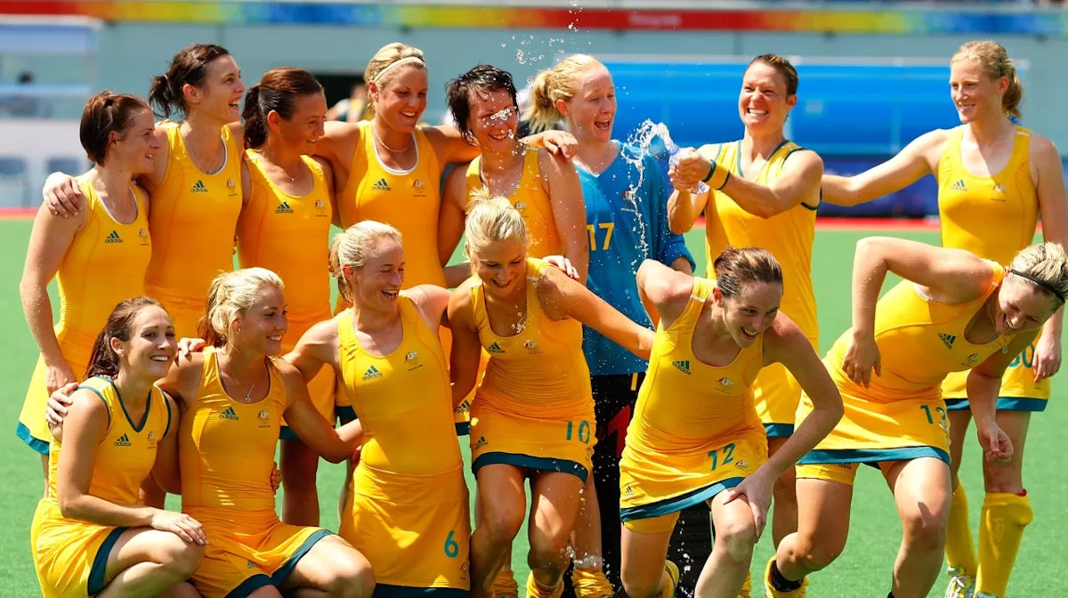 Nicole Arrold #14 of Australia douses her teammates with a bottle of water during the team photo after their 2-0 victory over Great Britain in the women's classification hockey match at the Olympic Green Hockey Field on Day 14 of the Beijing 2008 Olympic 