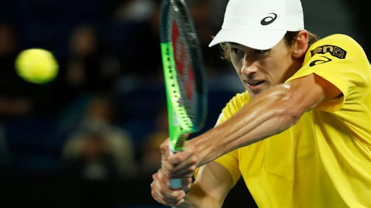  Alex de Minaur of Australia plays a backhand in his group B singles match against Stefanos Tsitsipas of Greece during day two of the 2021 ATP Cup at Rod Laver Arena on February 03, 2021 in Melbourne, Australia