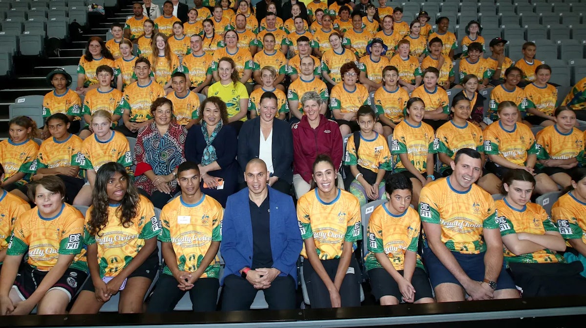 Students pose for a photo with former and current Olympic athletes including (front center left, Alex Winwood, front center, Patrick Johnson, and front left, Taliqua Clancy, during the launch of the Australian Olympic Committee 'Reflect' Reconciliation Ac