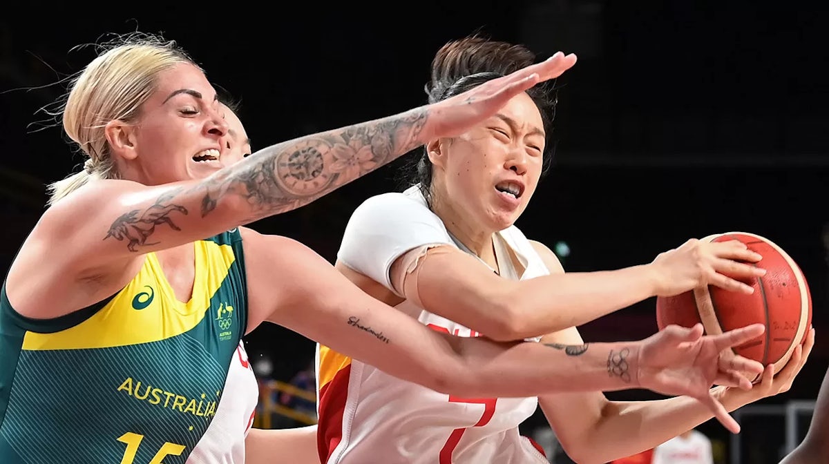 Cayla George (L) fights for the ball with China's Shao Ting in the women's preliminary round group C basketball match between China and Australia during the Tokyo 2020 Olympic Games at the Saitama Super Arena in Saitama