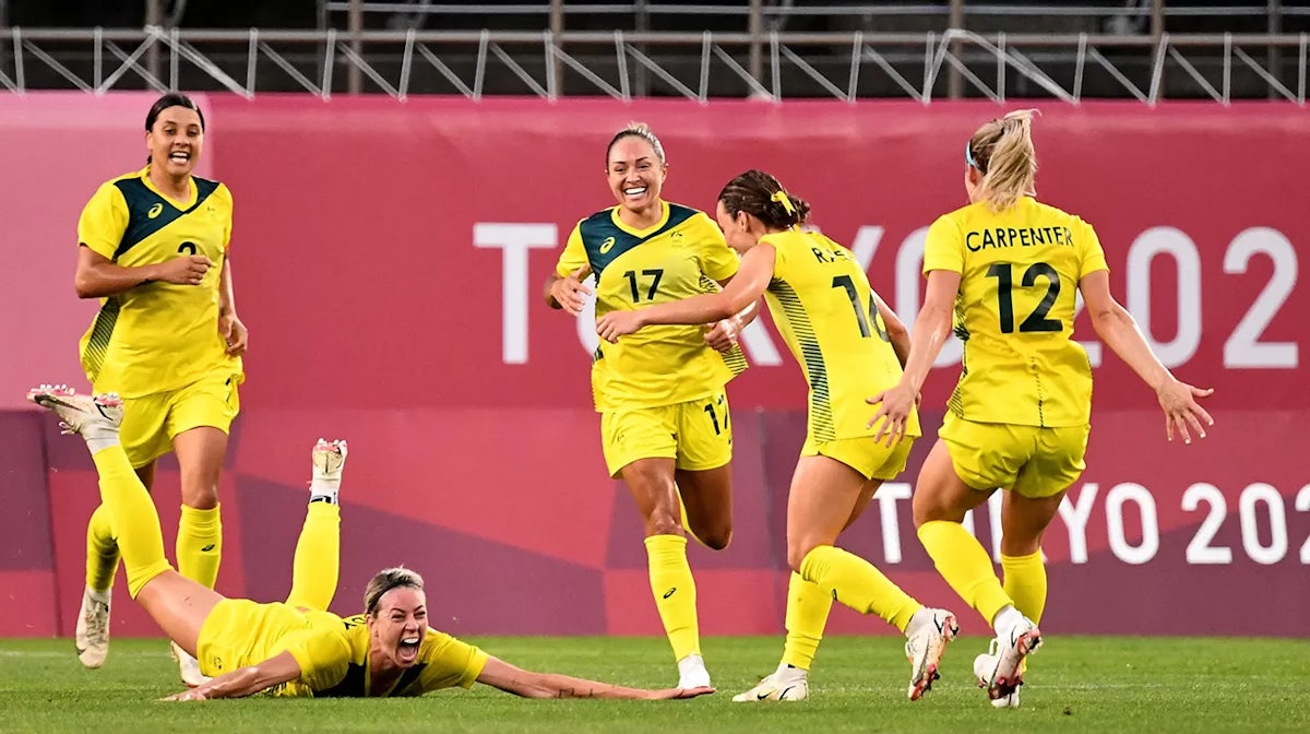 Alanna Kennedy (2nd L) dives into the pitch to celebrate her goal during the Tokyo 2020 Olympic Games women's quarter-final football match between Britain and Australia at Ibaraki Kashima Stadium
