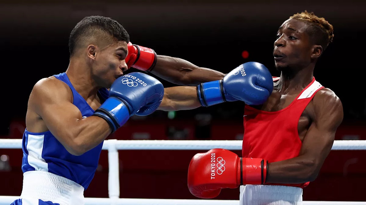 Patrick Chinyemba (R) of Zambia exchanges punches with Alex Winwood of Australia during the Men's Fly (48-52kg) on day three of the Tokyo 2020 Olympic Games at Kokugikan Arena