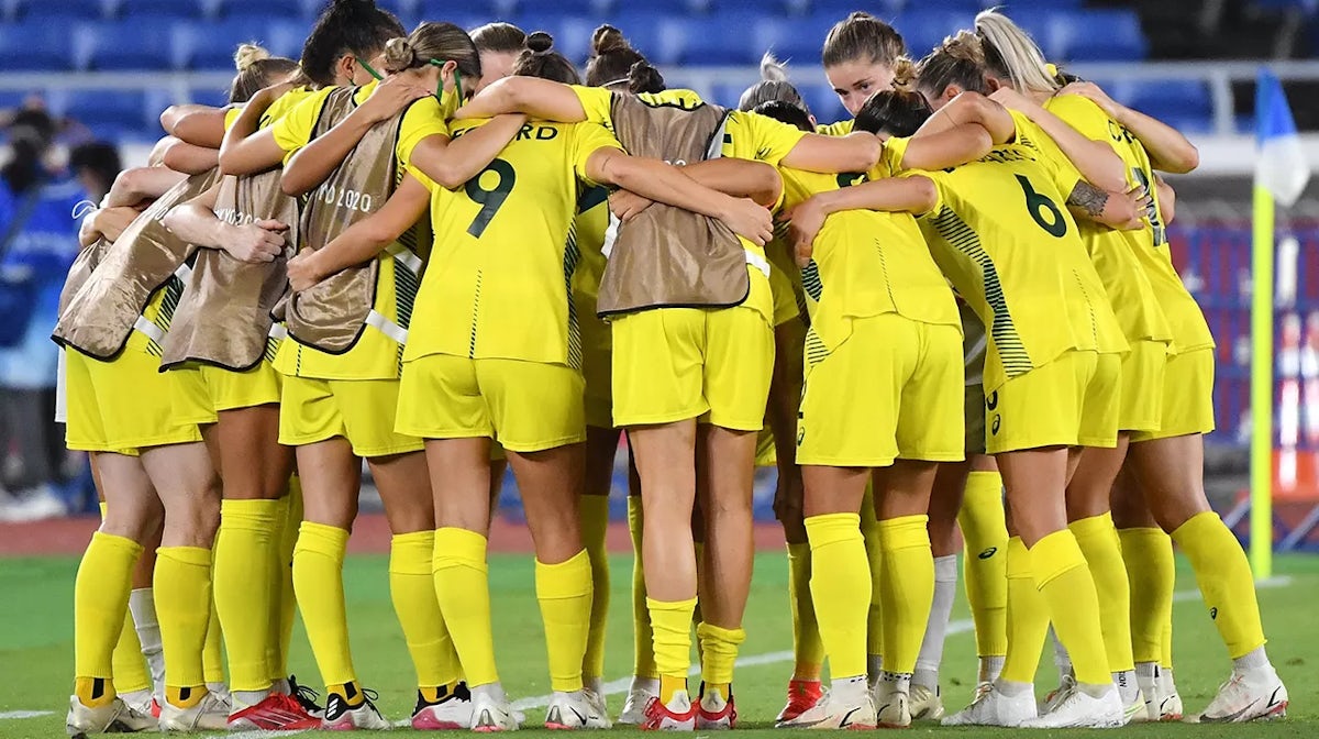 Australia's players gather in a huddle after their loss during the Tokyo 2020 Olympic Games women's semi-final football match between Australia and Sweden at Yokohama International Stadium in Yokohama on August 2