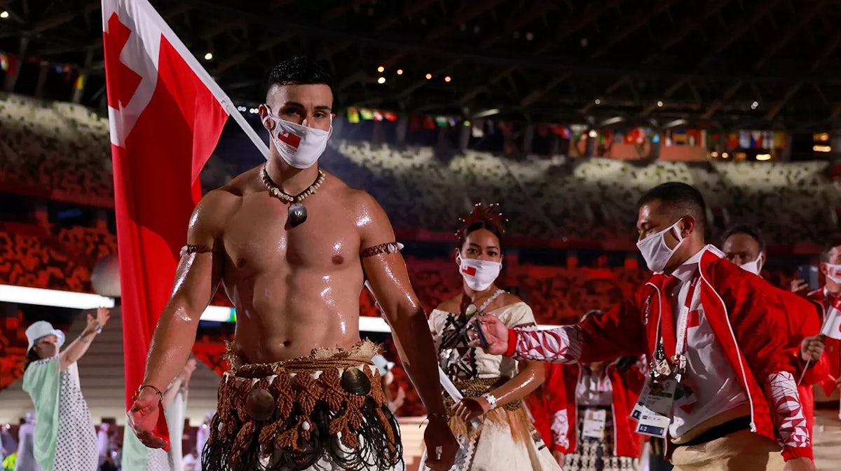Pita Taufatofua (L) and Malia Paseka (2L) lead their delegation as they parade during the opening ceremony of the Tokyo 2020 Olympic Games, at the Olympic Stadium, in Tokyo, on July 23, 2021.